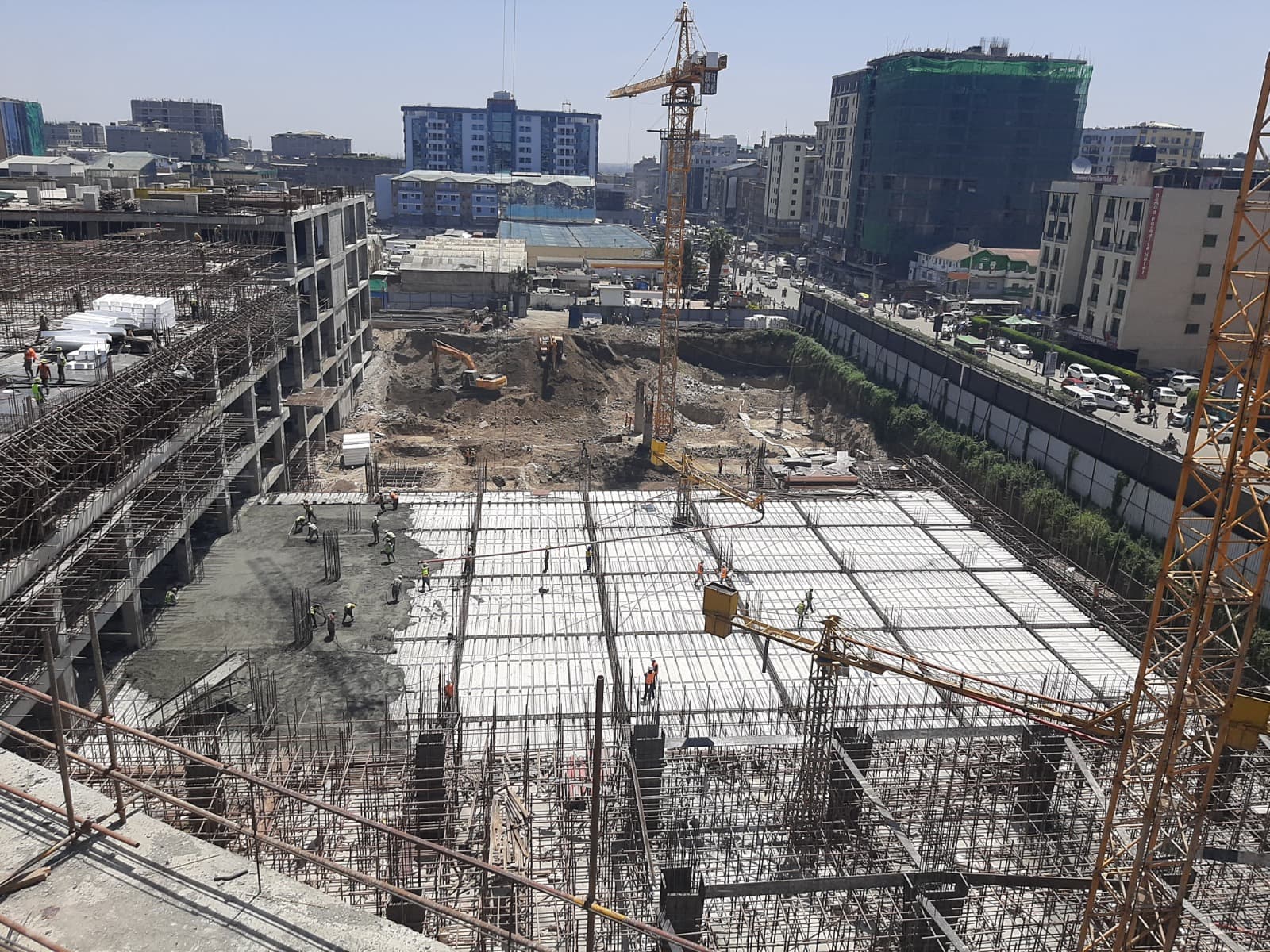 Wide construction view of BBS Mall in Eastleigh with a crane, reinforced slab grid, and EPS slab elements visible across the deck.