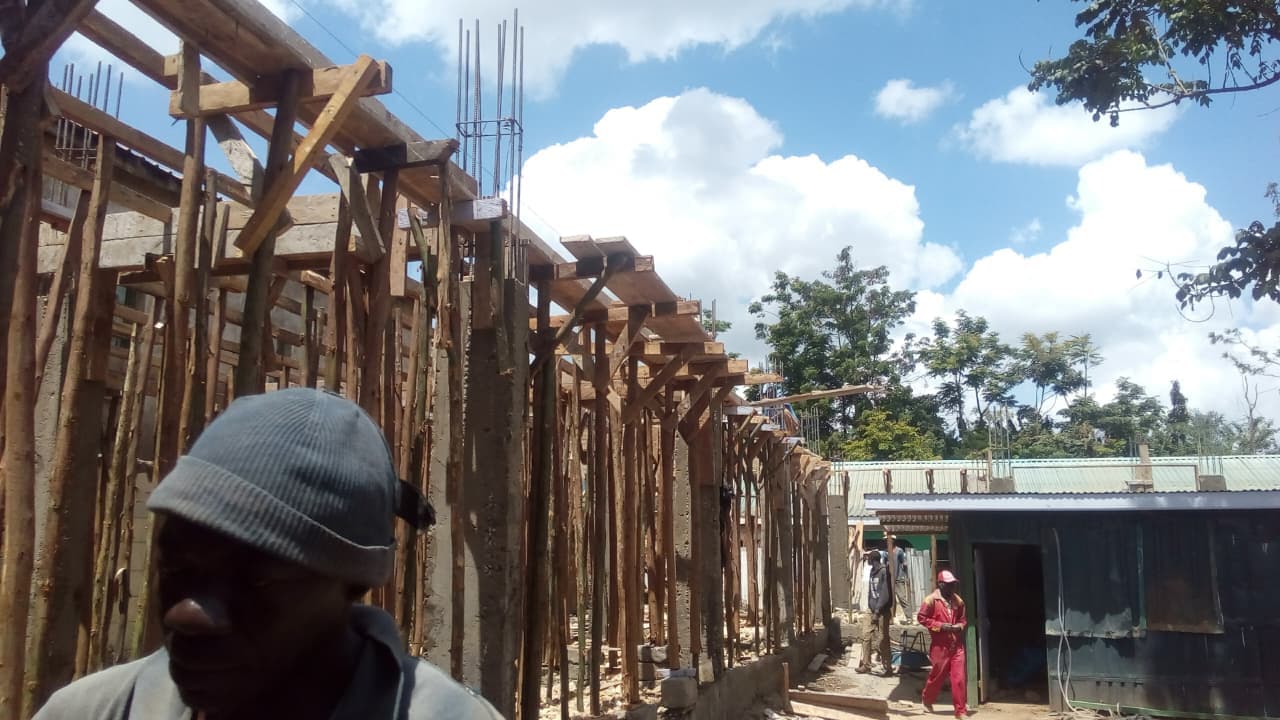Early construction view of the private hostel development with timber formwork, vertical members, and emerging room rhythm.