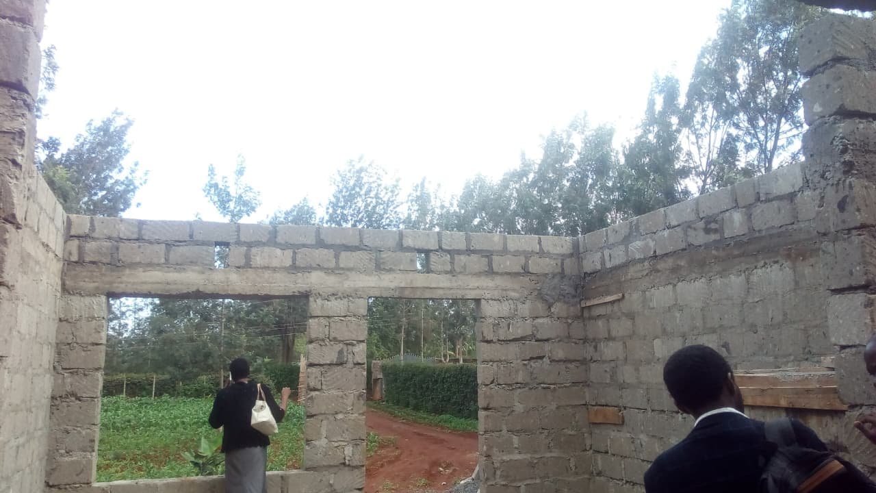 Interior walling view inside the private hostel development showing openings and room layout emerging.