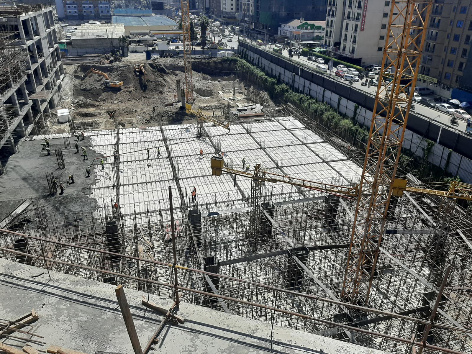Elevated construction view of the BBS Mall slab field in Eastleigh with repeated structural bays and a tower crane in the background.