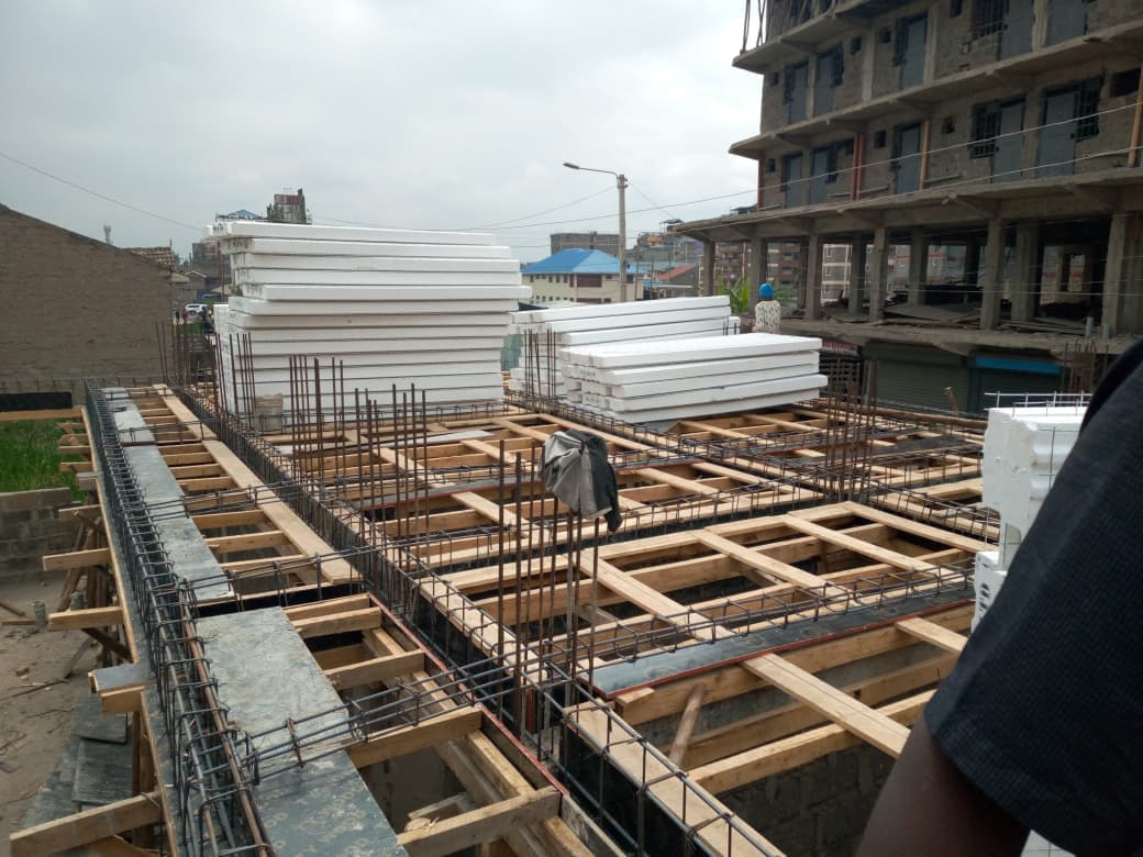 Stacked EPS 3D floor panels staged on a residential slab before installation in Kwa Ndege, Tassis.
